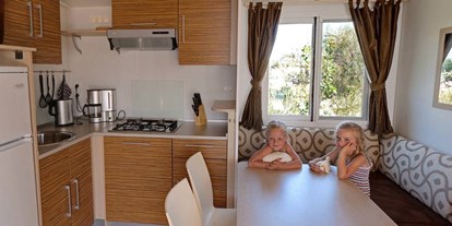 Luxuscamping - TV - Obala - Küche mit Eckbank - Camping Mare Pineta Baia Sistiana - Suncamp SunLodge Aspen von Suncamp auf Camping Mare Pineta Baia Sistiana